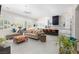 Modern living space with a stylish chaise lounge, adjacent kitchen, and natural light from windows at 9 Chalet Hills Ter, Henderson, NV 89052