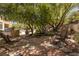 This home features an outdoor kitchen, mature trees, and a stone patio perfect for relaxing and entertaining at 9 Chalet Hills Ter, Henderson, NV 89052