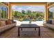 Inviting covered patio with furniture overlooking a serene backyard pool and waterfall at 9 Chalet Hills Ter, Henderson, NV 89052