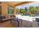 Covered patio overlooking a sparkling pool, rock waterfall and lush landscaping at 9 Chalet Hills Ter, Henderson, NV 89052