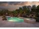 Backyard with a pool, spa, and lush landscaping, offering a private oasis perfect for relaxation and entertainment at 9 Chalet Hills Ter, Henderson, NV 89052