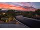 Scenic street view with a stunning sunset backdrop, highlighting the desirable neighborhood and peaceful surroundings at 9 Chalet Hills Ter, Henderson, NV 89052