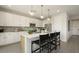 Modern kitchen with large island, white cabinetry, stainless appliances, and pendant lighting at 96 Via Franello, Henderson, NV 89011