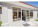 Close-up of the backyard featuring a sunroom with large glass windows and an artificial turf patch at 9813 Folsom Dr, Las Vegas, NV 89134