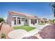 Backyard view with patio, tidy landscaping, and partial artificial turf; perfect for outdoor enjoyment and easy maintenance at 9813 Folsom Dr, Las Vegas, NV 89134