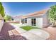 A view of the backyard showcasing a low-maintenance design with gravel landscaping and an artificial turf accent at 9813 Folsom Dr, Las Vegas, NV 89134
