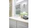 Bathroom featuring a white vanity with a large mirror, elegant lighting, and decorative accents at 9813 Folsom Dr, Las Vegas, NV 89134