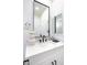 Close-up of a bathroom vanity with a marble countertop, black faucet, and decorative mirror at 9813 Folsom Dr, Las Vegas, NV 89134