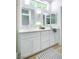 Bright bathroom featuring double sinks, quartz countertop, and stylish mirror and fixtures at 9813 Folsom Dr, Las Vegas, NV 89134
