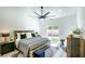 Modern bedroom featuring wood accents, neutral tones, and a large sliding door to the backyard at 9813 Folsom Dr, Las Vegas, NV 89134