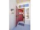 Inviting red front door and screen door with decorative glass and a 'welcome' mat at 9813 Folsom Dr, Las Vegas, NV 89134