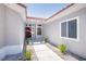 Front entrance of a single-story home with a red door and desert landscaping at 9813 Folsom Dr, Las Vegas, NV 89134