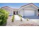 Front entrance of a single-story home with a red tile roof and desert landscaping at 9813 Folsom Dr, Las Vegas, NV 89134