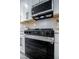 Kitchen with a range, stainless steel hood, and white cabinets at 9813 Folsom Dr, Las Vegas, NV 89134