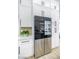 Modern refrigerator with a black glass door and custom cabinetry at 9813 Folsom Dr, Las Vegas, NV 89134