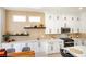 Modern kitchen with white cabinets, black hardware, stainless steel appliances, and stylish countertops at 9813 Folsom Dr, Las Vegas, NV 89134