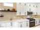 Modern kitchen featuring white cabinetry, quartz countertops, and stainless steel appliances at 9813 Folsom Dr, Las Vegas, NV 89134