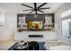 A stylish living room with ceiling fan, built-in entertainment center, and white sofa on a blue rug at 9813 Folsom Dr, Las Vegas, NV 89134