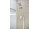 Spa-like shower with white and wood-look tiles, recessed niche, and modern shower head and handheld at 9813 Folsom Dr, Las Vegas, NV 89134