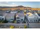 Community aerial view of homes nestled in a desert landscape with mountains in the distance at 10031 Fletcher Peak Ave, Las Vegas, NV 89178