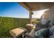 Relaxing balcony area with comfortable seating, privacy screen, and a view of the surrounding landscape at 10031 Fletcher Peak Ave, Las Vegas, NV 89178