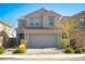 Lovely two-story home with desert landscaping, a gray garage door, and a welcoming front entrance at 10031 Fletcher Peak Ave, Las Vegas, NV 89178