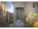 Inviting front entrance features a wreath on the front door and charming landscaping at 10031 Fletcher Peak Ave, Las Vegas, NV 89178
