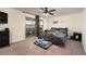Spacious main bedroom features a sliding glass door and a ceiling fan, creating a relaxing retreat at 10031 Fletcher Peak Ave, Las Vegas, NV 89178