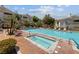 Community pool and spa area with lounge chairs and well-maintained landscaping at 10116 Jacob Pl # 104, Las Vegas, NV 89144