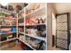 Spacious pantry with well-stocked shelves and stylish patterned door at 10370 Sweet Laurel St, Las Vegas, NV 89178