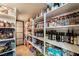 Organized pantry with white shelving and a variety of food and cooking supplies at 10370 Sweet Laurel St, Las Vegas, NV 89178