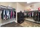 Well-organized walk-in closet with hanging rods, shelving, and dark wood floors at 10370 Sweet Laurel St, Las Vegas, NV 89178