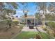 Private backyard boasts a custom patio, fire pit, manicured lawn, and desert landscaping at 1658 Autumn Rust Dr, Las Vegas, NV 89119