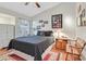 A bedroom featuring a queen bed, ceiling fan, and closet with a bright window and a classic wood nightstand at 1658 Autumn Rust Dr, Las Vegas, NV 89119