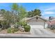 Charming single-story home with a two-car garage, landscaped front yard and inviting curb appeal at 1658 Autumn Rust Dr, Las Vegas, NV 89119