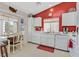Efficient kitchen featuring white cabinetry, modern appliances, and a cozy dining area at 1658 Autumn Rust Dr, Las Vegas, NV 89119