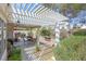 The covered patio provides a relaxing outdoor space with stylish pergola and garden views at 1658 Autumn Rust Dr, Las Vegas, NV 89119