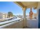 View from the balcony showcasing parking area, surrounding buildings, and a clear blue sky at 1979 Cutlass Dr # 1979, Henderson, NV 89014