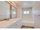 Bright bathroom featuring tiled shower/tub combination, modern vanity and mirrors and updated fixtures at 1979 Cutlass Dr # 1979, Henderson, NV 89014