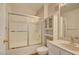 Bathroom featuring glass shower door, cabinet and sink with a large mirror and updated lighting at 1979 Cutlass Dr # 1979, Henderson, NV 89014