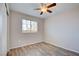 Bedroom with wood-look floors, neutral walls, and a window with blinds for privacy at 1979 Cutlass Dr # 1979, Henderson, NV 89014