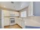 Bright kitchen features white cabinets, countertops, and appliances at 1979 Cutlass Dr # 1979, Henderson, NV 89014