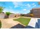 Large backyard showcases a well-manicured lawn and desert landscaping, creating a serene outdoor environment at 4708 Grand Rock Dr, North Las Vegas, NV 89081