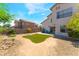 Expansive backyard featuring a small lawn, desert landscaping, and a patio area, perfect for outdoor living at 4708 Grand Rock Dr, North Las Vegas, NV 89081