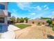 A spacious backyard featuring artificial turf surrounded by desert landscaping, ideal for low-maintenance outdoor enjoyment at 4708 Grand Rock Dr, North Las Vegas, NV 89081