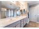 Bathroom with a dual sink vanity, a large mirror, and modern lighting fixtures at 4708 Grand Rock Dr, North Las Vegas, NV 89081