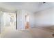 Spacious bedroom with neutral carpet leading into bathroom at 4708 Grand Rock Dr, North Las Vegas, NV 89081