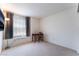 Cozy bedroom featuring a small desk by the window with neutral walls and carpet at 4708 Grand Rock Dr, North Las Vegas, NV 89081