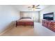 Bedroom with neutral carpet, a window, TV, and a ceiling fan at 4708 Grand Rock Dr, North Las Vegas, NV 89081