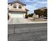 Two-story home featuring a two-car garage, tidy landscaping, and mature trees at 4708 Grand Rock Dr, North Las Vegas, NV 89081